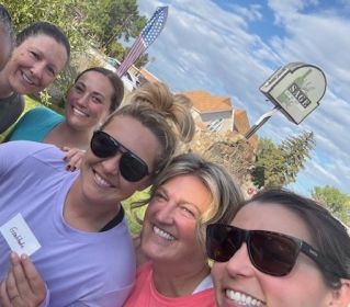 A man and woman enjoy an outdoor yoga session with water bottles in the scenic hills of Portugal.